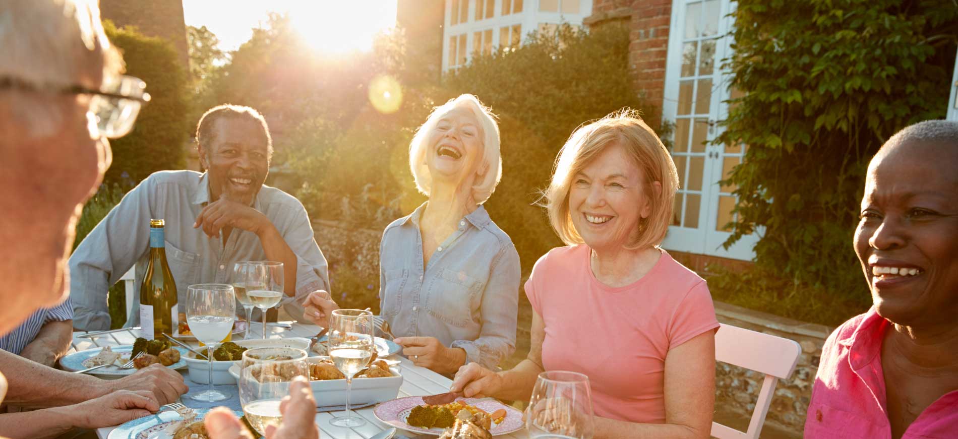 senior living apartment community Fun group enjoying dinner