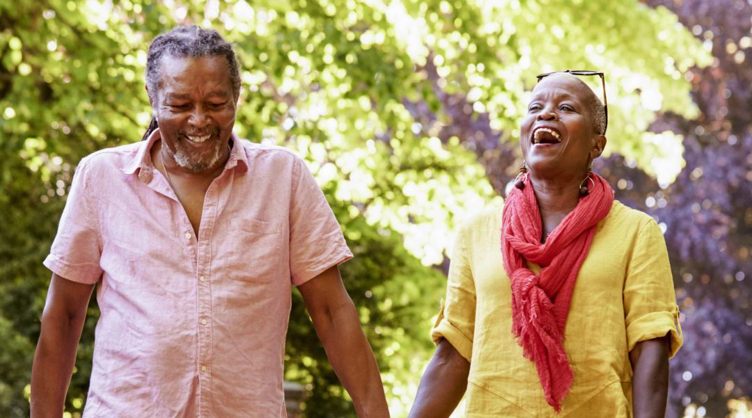 Senior couple walking with a pet